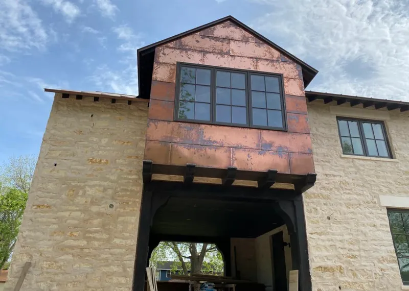 Copper metal panel facade on a stone building for Skylight Installation in Indio
